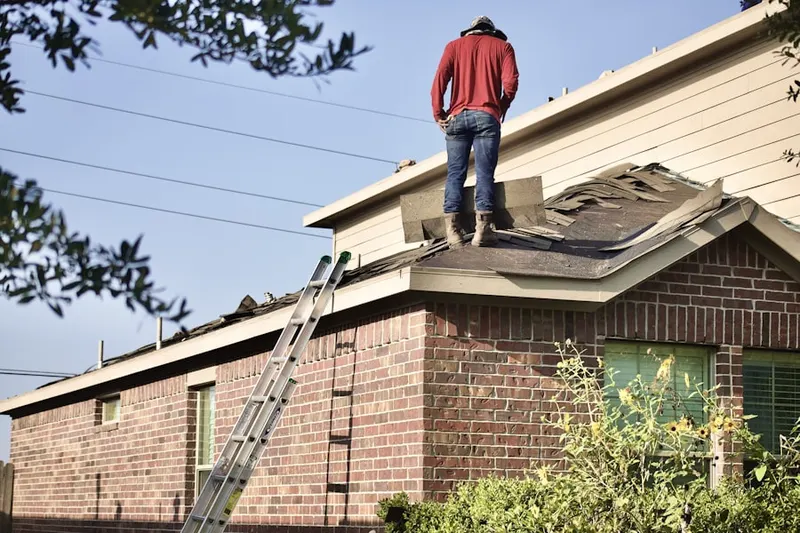 Professional roofer working on a residential roof in Oak Creek Village
